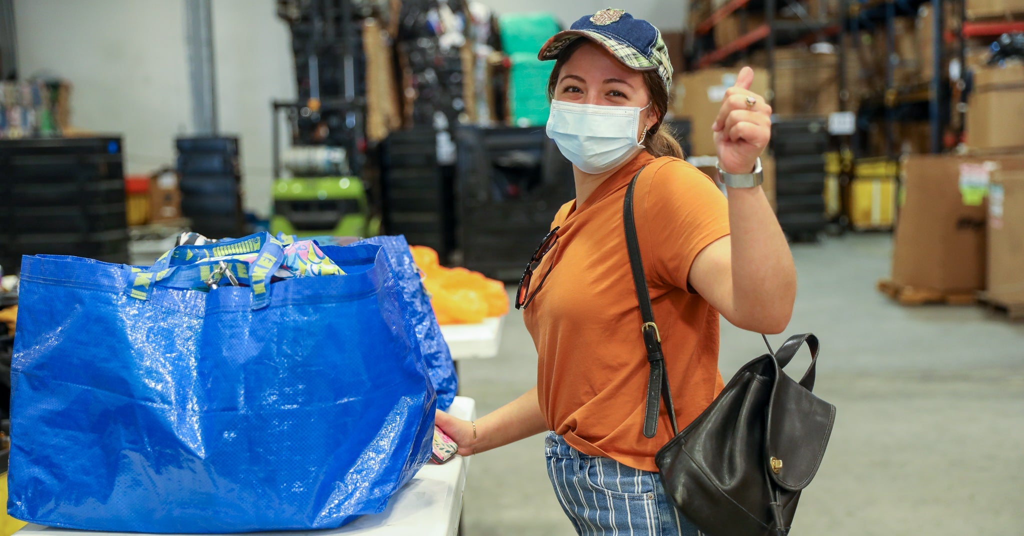 Woman sourcing wholesale inventory at warehouse.